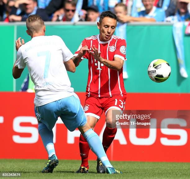 Dennis Grote of Chemnitz and Rafinha of Bayern Muenchen battle for the ball during the DFB Cup first round match between Chemnitzer FC and FC Bayern...