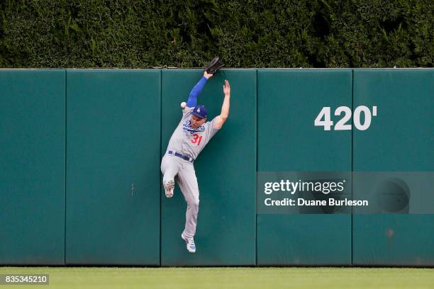 Center Fielder Joc Pederson of the Los Angeles Dodgers misplays a fly ball hit to the center field wall by Justin Upton of the Detroit Tigers during...