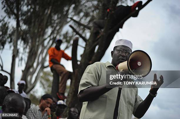 Malik Obama, a step brother to America's Democratic presidential hopeful Barak Obama, talks with the aid of a bulhorn November 2, 2008 to villagers...