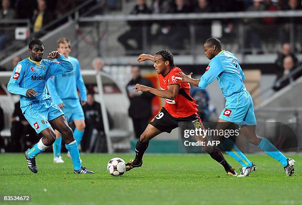 Rennes' forward Jimmy Briand vies with Sochaux' midfielder Valery Mezague and Sochaux' defender Radiu Afolabi during the French L1 football match...