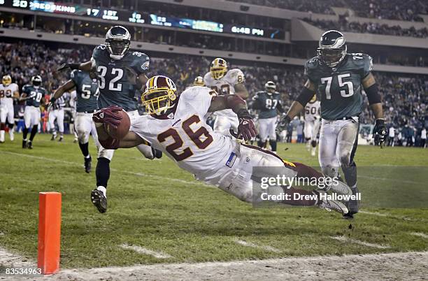 Washington Redskins running back Clinton Portis dives into the end zone in the fourth quarter to give the Redskins the lead and a playoff berth...
