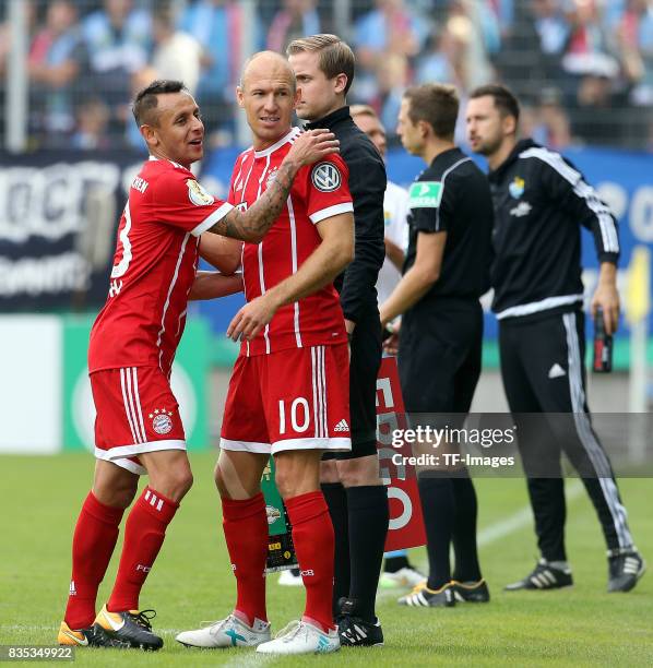 Rafinha of Bayern Muenchen shakes hands with Arjen Robben of Bayern Muenchen during the DFB Cup first round match between Chemnitzer FC and FC Bayern...
