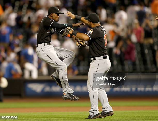 Dee Gordon and Tomas Telis of the Miami Marlins celebrate the 3-1 win over the New York Mets on August 18, 2017 at Citi Field in the Flushing...