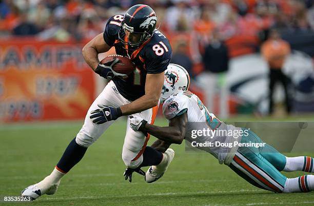 Tight end Nate Jackson of the Denver Broncos makes a reception as cornerback Andre Goodman of the Miami Dolphins makes the tackle during NFL action...