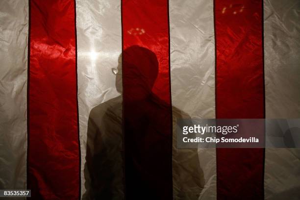 McCain campaign manager Rick Davis stands in front of a flag while listening to Republican presidential nominee Sen. John McCain hold a town hall...