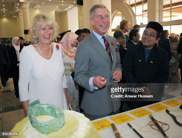 Prince Charles, Prince of Wales and Camilla, Duchess of Cornwall laugh as they tour a craft fair at the University on November 1, 2008 in Brunei...