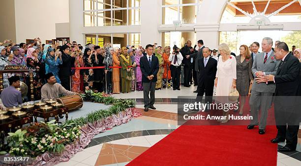 Prince Charles, Prince of Wales and Camilla, Duchess of Cornwall walk past a group of musicians at the University on November 1, 2008 in Brunei...