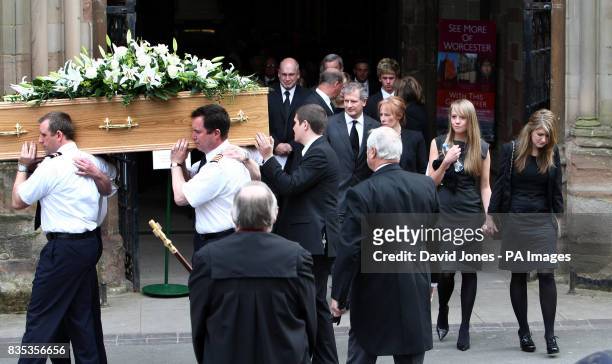 The coffin of helicopter co-pilot Richard Menzies, followed by his girlfriend Katherine Botham and sister Laura Menzies , is carried from his funeral...