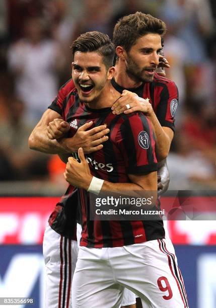 Andre Silva of AC Milan celebrates his second goal with his team-mate Fabio Borini during the UEFA Europa League Qualifying Play-Offs round first leg...