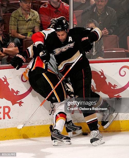 Jim Vandermeer of the Calgary Flames is checked into the boards by Ryan Getzlaf of the Anaheim Ducks during the game on November 2, 2008 at Honda...