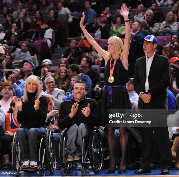 Marathon winners Edith Hunkeler, Kurt Fearnley, Paula Radcliffe and Marilson Gomes dos Santos attend the Milwaukee Bucks vs New York Knicks game at...