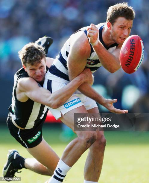 Will Hoskin-Elliott tackles Lachie Henderson of the Cats during the round 22 AFL match between the Collingwood Magpies and the Geelong Cats at...