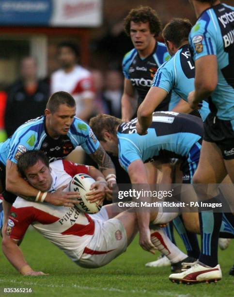 St Helens' Paul Clough is tackled by Bradford's Terry Newton and Nick Scruton during the engage Super league match at Knowsley Road, St Helens.