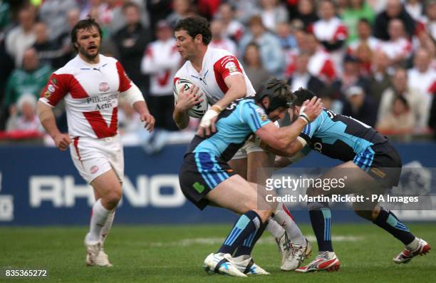 St Helens' Paul Wellens is tackled by Bradford's Steve Menzies and Ben Jeffries during the engage Superleague match at Knowsley Road, St Helens.