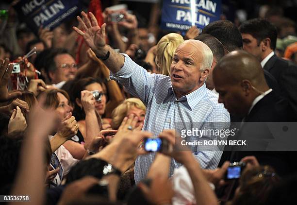 Republican presidential candidate John McCain greets supporters at a midnight campaign rally at Bank United Center in Coral Gables, Florida in the...