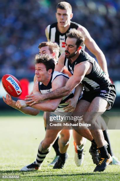 Steele Sidebottom of the Magpies tackles Patrick Dangerfield of the Cats during the round 22 AFL match between the Collingwood Magpies and the...