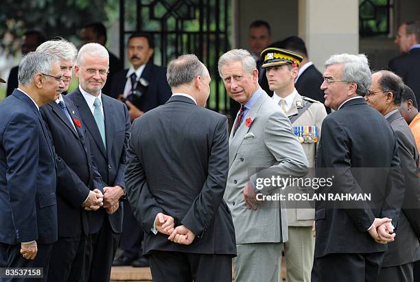 Britain's Prince Charles talks to the ambassadors to Indonesia from various countries during a visit to the Pulo Menteng Commonwealth War Graves...