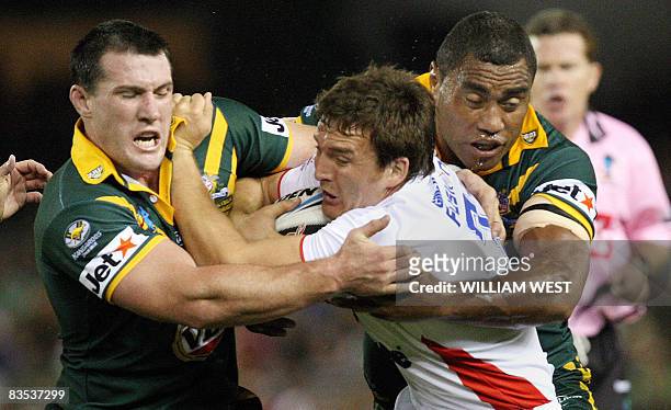 Martin Gleeson of England is tackled by Australia's Paull Gallen and Petero Civoniceva in their Rugby League World Cup match at the Docklands Stadium...