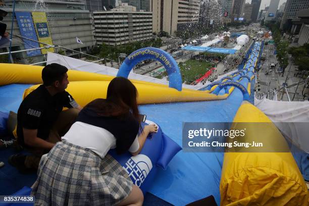 South Korean woman slides down on an inflatable bobsleigh during the 'Bobsleigh In the City' on August 19, 2017 in Seoul, South Korea. The...