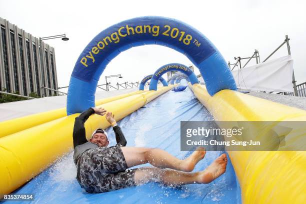Man slides down on an inflatable bobsleigh during the 'Bobsleigh In the City' on August 19, 2017 in Seoul, South Korea. The 22-metre-high...