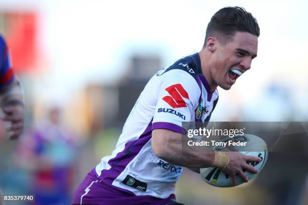 Brodie Croft of the Storm scores a try during the round 24 NRL match between the Newcastle Knights and the Melbourne Storm at McDonald Jones Stadium...