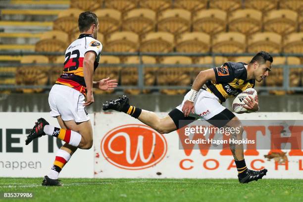 Beaudein Waaka of Taranaki crosses the line for a try while Tyler Campbell of Waikato looks on during the round one Mitre 10 Cup match between...