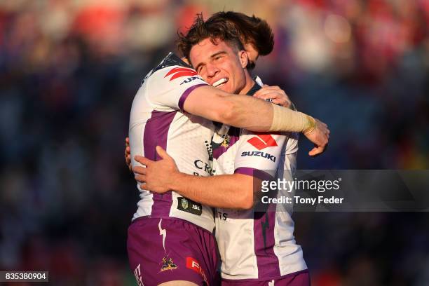 Brodie Croft of the Storm celebrates a try with a team mate during the round 24 NRL match between the Newcastle Knights and the Melbourne Storm at...