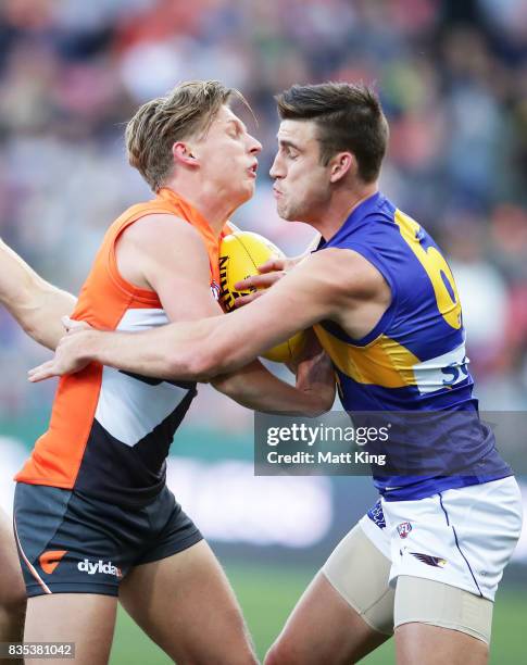 Lachie Whitfield of the Giants is challenged by Elliot Yeo of the Eagles during the round 22 AFL match between the Greater Western Sydney Giants and...