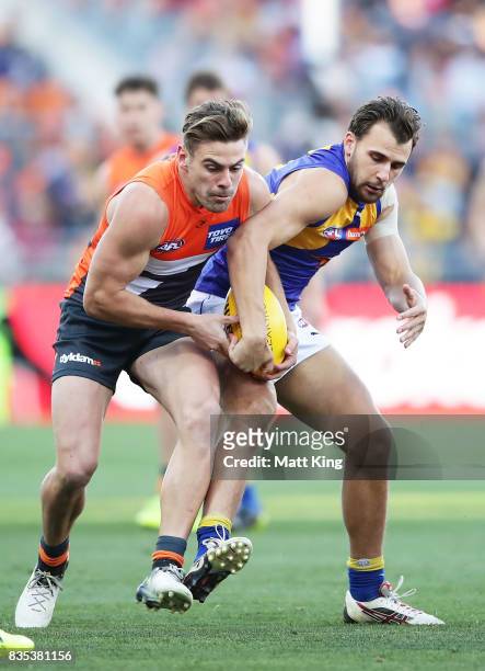 Stephen Coniglio of the Giants competes for the ball against Dom Sheed of the Eagles during the round 22 AFL match between the Greater Western Sydney...