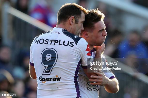 Storm players celebrate a try from Brodie Croft during the round 24 NRL match between the Newcastle Knights and the Melbourne Storm at McDonald Jones...