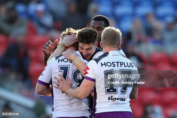 Storm players celebrate a try from Brodie Croft during the round 24 NRL match between the Newcastle Knights and the Melbourne Storm at McDonald Jones...