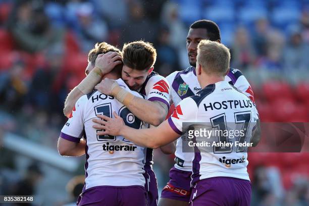 Storm players celebrate a try from Brodie Croft during the round 24 NRL match between the Newcastle Knights and the Melbourne Storm at McDonald Jones...