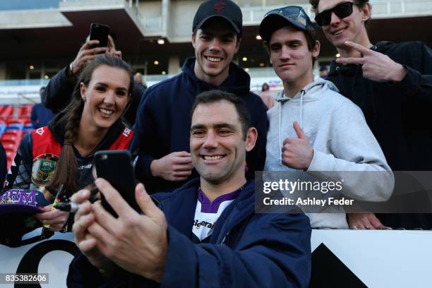 Cameron Smith of the Storm takes a selfie with fans during the round 24 NRL match between the Newcastle Knights and the Melbourne Storm at McDonald...