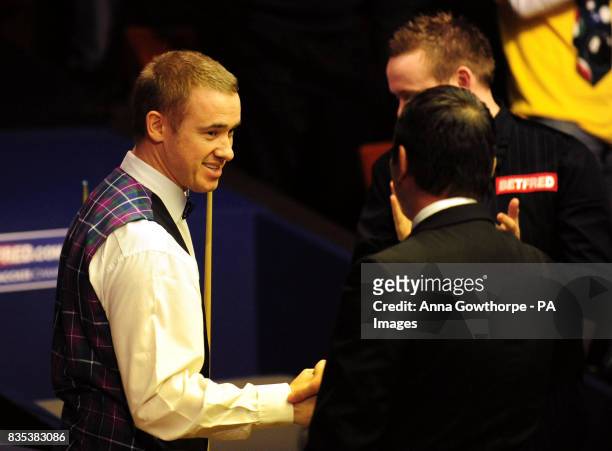 Stephen Hendry is congratulated by referee Terry Camilleri after scoring a maximum 147 break during the Betfred.com World Snooker Championship at The...