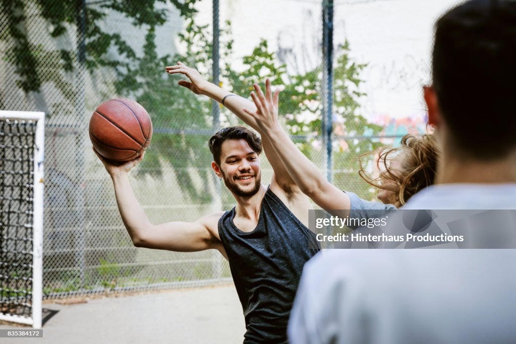Basketball Players Competing For Control Of The Ball During Afternoon Match