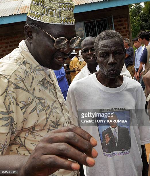 Malik Obama , the half-brother of US Democratic presidential hopeful Barak Obama talks to a relative at the Obama's rural home in the village of...
