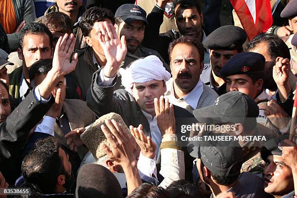 Pro-India Kashmiri leader and president of National Conference Omar Abdulla waves to supporters after filling his nomination papers in Ganderbal...