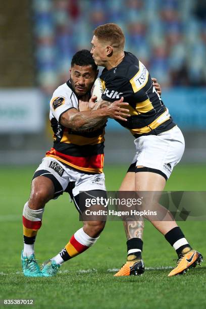 Declan O'Donnell of Taranaki breaks the tackle of Pele Cowley of Waikato during the round one Mitre 10 Cup match between Taranaki and Waikato at...