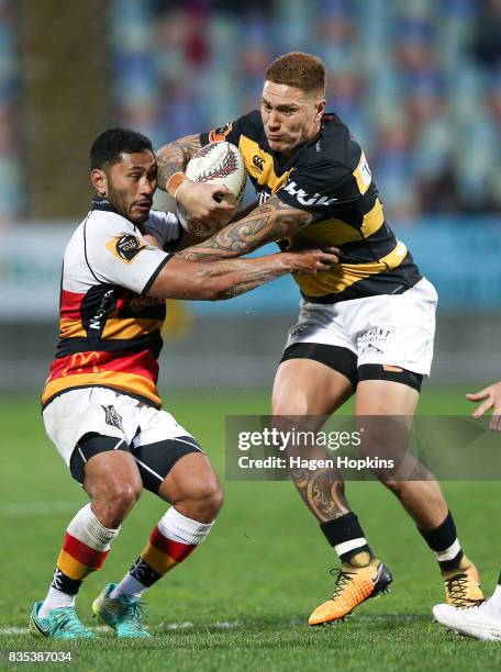 Declan O'Donnell of Taranaki breaks the tackle of Pele Cowley of Waikato during the round one Mitre 10 Cup match between Taranaki and Waikato at...