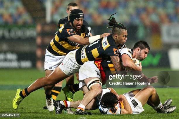 Luke Jacobson of Waikato is tackled by Sean Wainui of Taranaki during the round one Mitre 10 Cup match between Taranaki and Waikato at Yarrow Stadium...