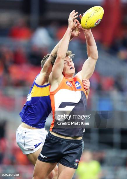 Adam Tomlinson of the Giants is challenged by Jack Redden of the Eagles during the round 22 AFL match between the Greater Western Sydney Giants and...