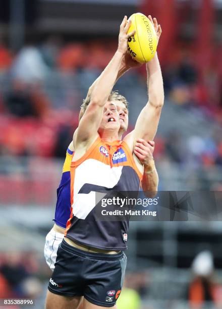 Adam Tomlinson of the Giants is challenged by Jack Redden of the Eagles during the round 22 AFL match between the Greater Western Sydney Giants and...