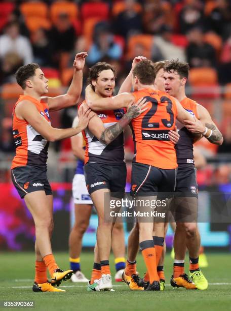 Nathan Wilson of the Giants celebrates with team mates after kicking a long range goal during the round 22 AFL match between the Greater Western...