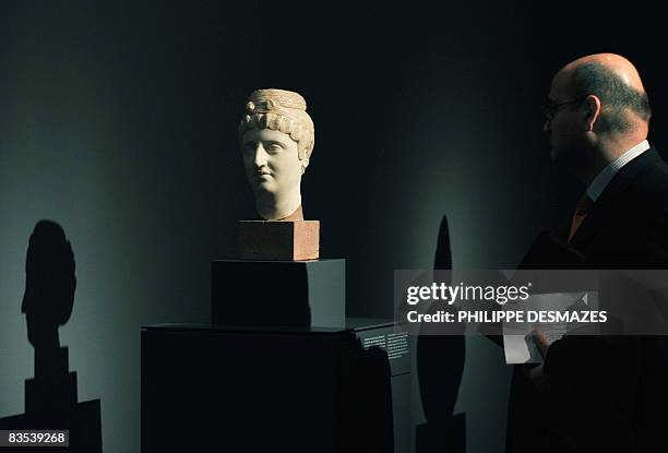 Man looks on November 3, 2008 at the sculpture "Portrait of the Empress Faustina Maior" at the Prado museum as part of a new exhibition "Among Gods...