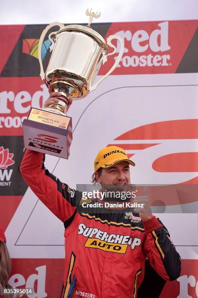 Chaz Mostert driver of the Supercheap Auto Racing Ford Falcon FGX celebrates on the podium after race 17 for the Sydney SuperSprint, which is part of...