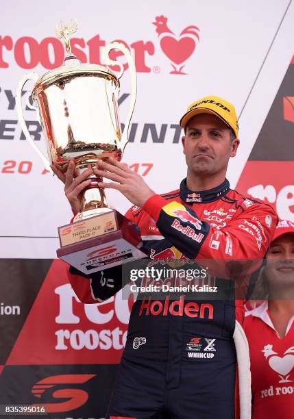 Jamie Whincup driver of the Red Bull Holden Racing Team Holden Commodore VF celebrates on the podium after race 17 for the Sydney SuperSprint, which...