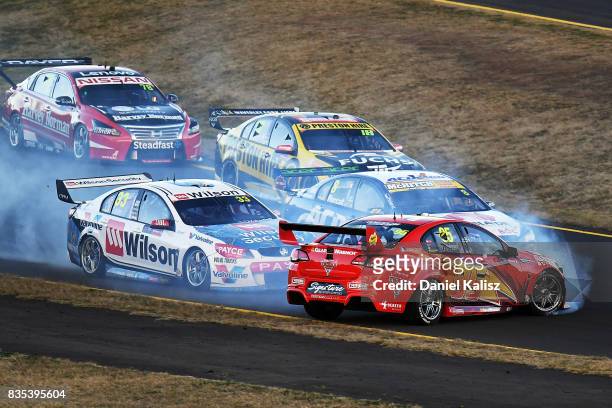 Will Davison drives the Tekno Woodstock Racing Holden Commodore VF spins at the start as Garth Tander drives the Wilson Security Racing GRM Holden...
