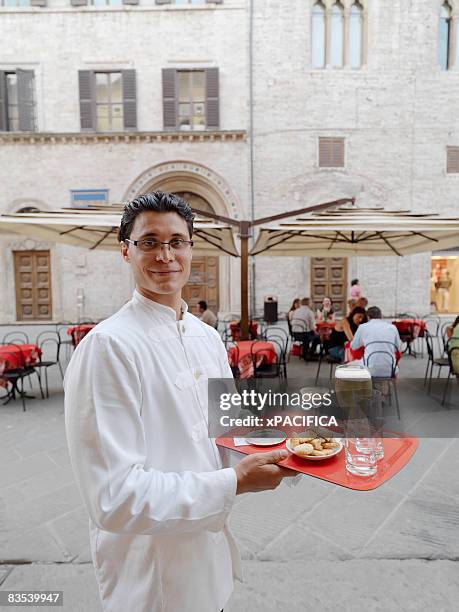 a waiter with a tray in hand. - italy beer stock-fotos und bilder