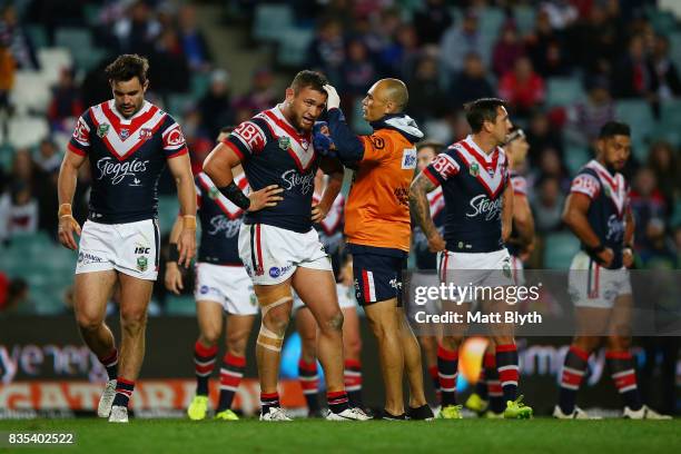 Jared Waerea-Hargreaves of the Roosters is attended to by a trainer during the round 24 NRL match between the Sydney Roosters and the Wests Tigers at...