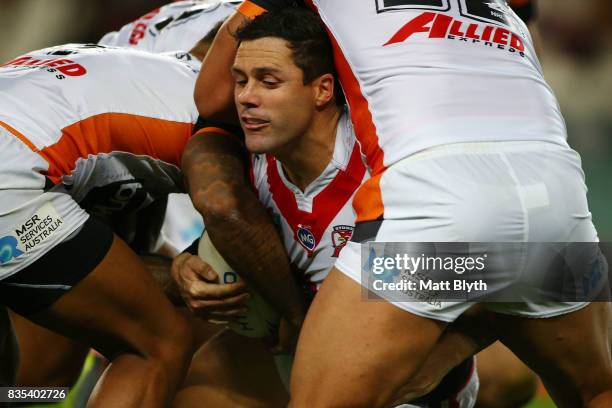 Michael Gordon of the Roosters is tackled during the round 24 NRL match between the Sydney Roosters and the Wests Tigers at Allianz Stadium on August...